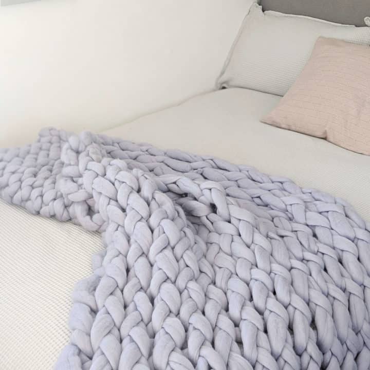 blue grey chunky knit blanket on bed