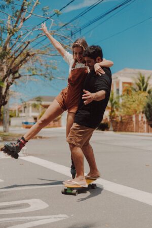 Couple having fun together on a skateboard.